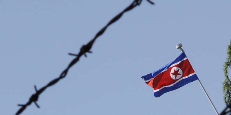 Image: The North Korean flag flies over its emb