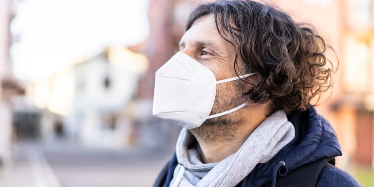 MIddle age man wearing in EU obligatory FFP2/KN95/N95/ protective mask