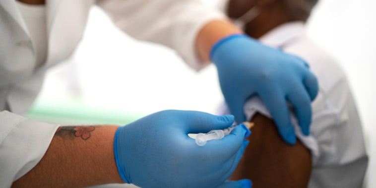 Image: Vaccine being applied in a patient's arm