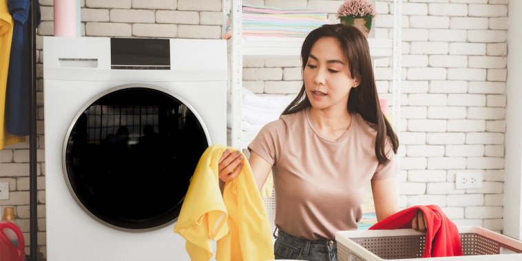 Woman organizing her laundry in her laundry room