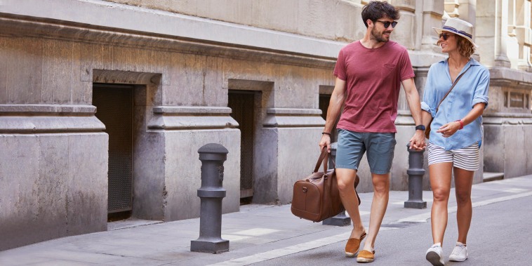 Boyfriend and Girlfriend strolling outside wearing summer clothes
