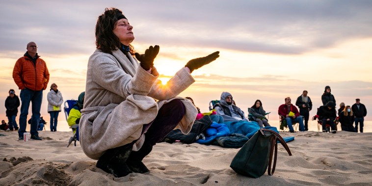Parishioners gather on a beach for an Easter Sunday service at sunrise hosted by Hope Community Church of Manasquan, on April 4, 2021, in Masaquan, N.J.