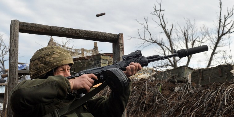 Image: A member of the Ukrainian armed forces fires in an attempt to shoot down an alleged unmanned aerial vehicle (UAV) at fighting positions on the line of separation from pro-Russian rebels near Donetsk, Ukraine