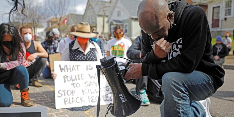 Image: Demonstrators kneel for a moment of silence during a march from the Governor's Residence the weekend before closing arguments in the Derek Chauvin trial in St. Paul, Minn.