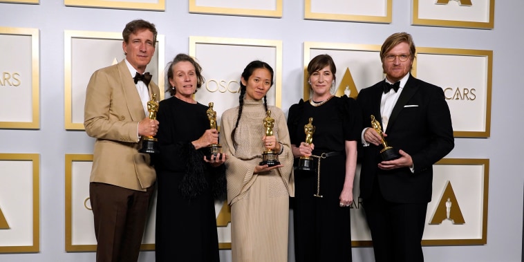 Image: Producers Peter Spears, from left, Frances McDormand, Chloe Zhao, Mollye Asher and Dan Janvey, winners of the award for best picture for \"Nomadland,\" pose in the press room at the Oscars