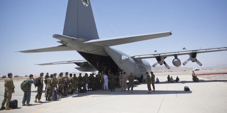 Afghan National Army soldiers line up to get into a C-130 Hercules at Kandahar Air Base on Aug. 18, 2015.