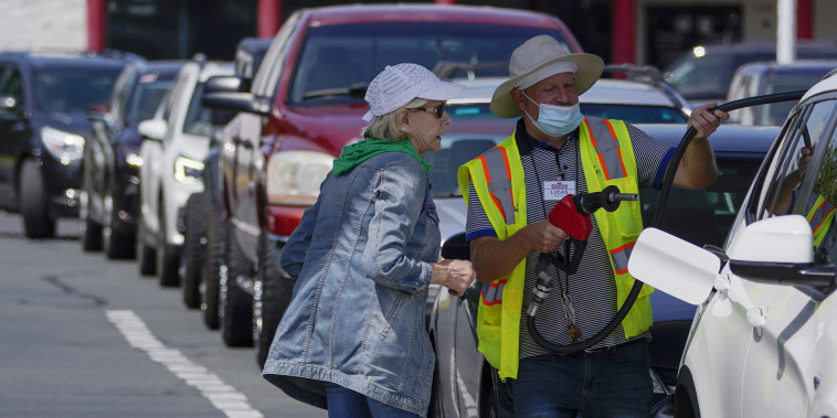 Image: Customers wait in line to fill their cars with gas at Costco on May 11, 2021, in Charlotte, N.C.