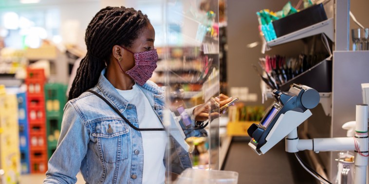 Customer making payment with nfc technology at supermarket