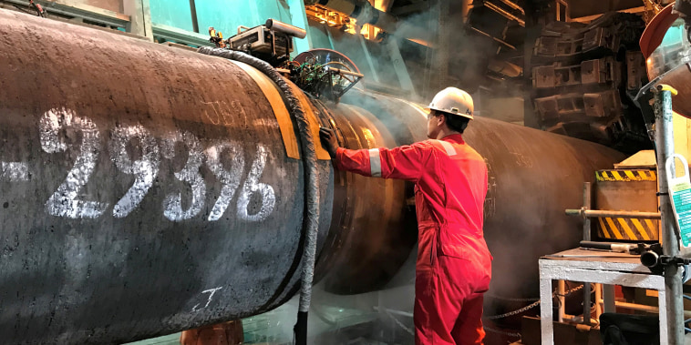 Image: FILE PHOTO: A specialist works onboard the Allseas' deep sea pipe laying ship Solitaire to prepare a pipe for Nord Stream 2 pipeline in the Baltic Sea