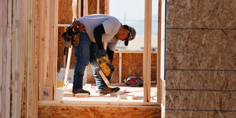 Image: A contractor cuts lumber