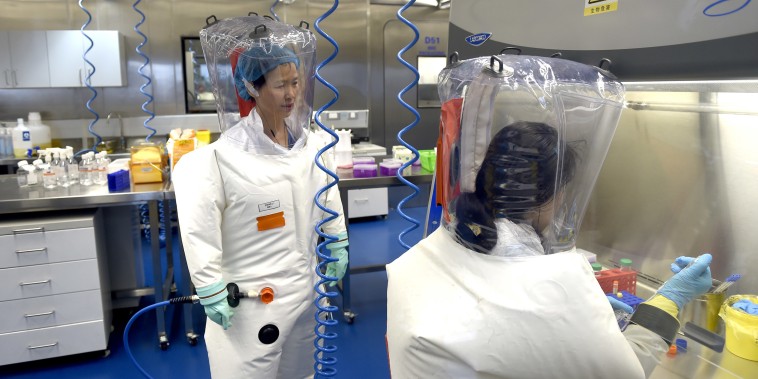 Image: Virologist Shi Zheng-li, left, works with her colleague in the P4 lab of Wuhan Institute of Virology in Wuhan in central China's Hubei province.