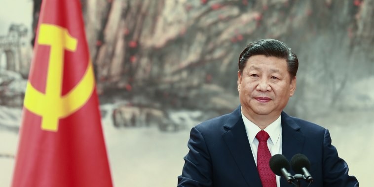 Image: Chinese President Xi Jinping speaks at the podium during the unveiling of the Communist Party's new Politburo Standing Committee at the Great Hall of the People in Beijing.