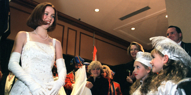The new Queen of the court of Love and Beauty, Miss Elizabeth Claire Kemper speaks briefly with her two pages Katy Angevine, left, 8, and Jacqueline Probst, 7, before taking the stage to accept her crown from the veiled prophet on Dec. 23, 1999.