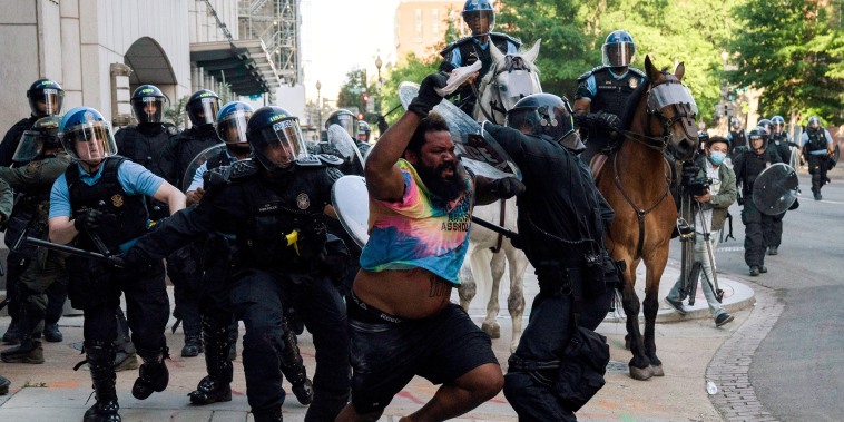 Image: Riot police clear Lafayette Park for a photo opportunity by President Donald Trump in Washington