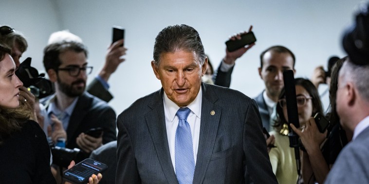 Image: Reporters surround Sen. Joe Manchin, D-W.V. as he heads to a vote in the Senate on June 8, 2021.