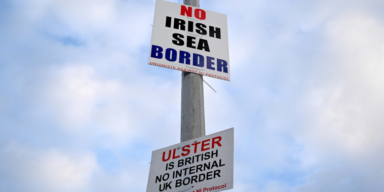 Image: Signs reading 'No Irish Sea border' and 'Ulster is British, no internal UK Border' are seen affixed to a lamp post at the Port of Larne, Northern Ireland