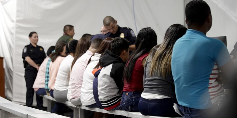 Migrants who are applying for asylum in the United States go through a processing area at a new tent courtroom at the Migration Protection Protocols Immigration Hearing Facility on Sept. 17, 2019, in Laredo, Texas.
