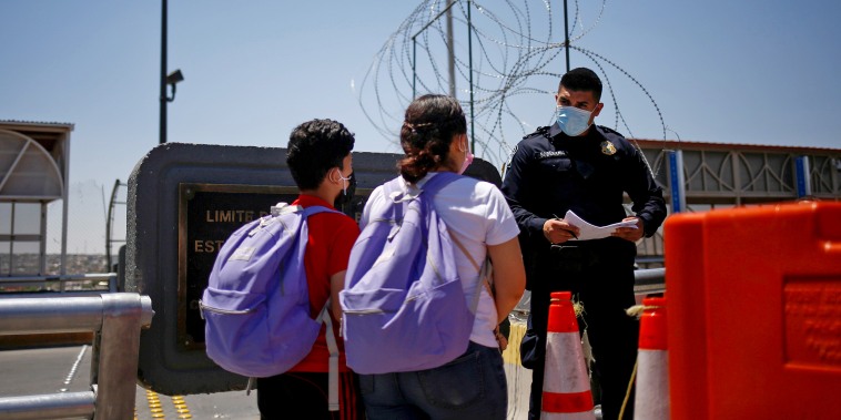 Image: Migrants from Central America walk across the Paso del Norte international border bridge in Ciudad Juarez