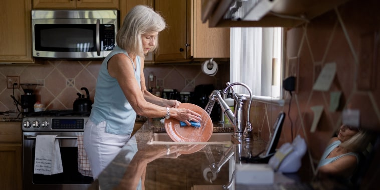 Image: Margo Woodacre washes dishes at home in Landenberg, Pa., on June 10, 2021.