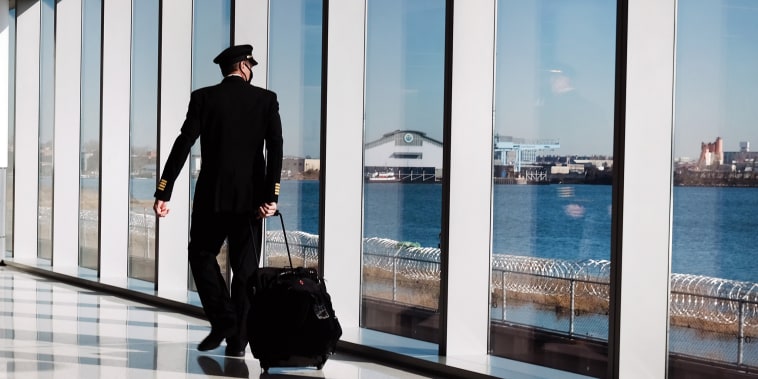 Image: A pilot moves through New York's LaGuardia Airport on Dec. 3, 2020.