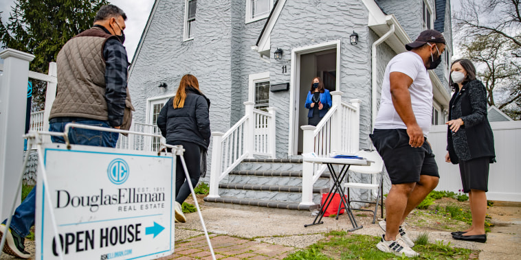 Real estate agents work an open house in West Hempstead, N.Y., on April 18, 2021.