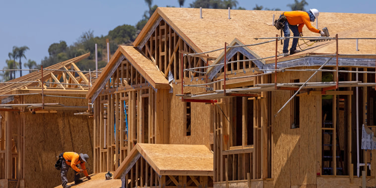 Image: Workers build residential single family homes in Valley Center, Calif., on June 3, 2021.
