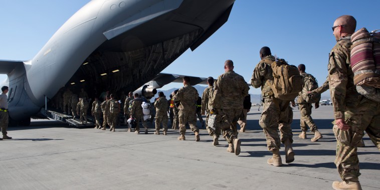 Image: U.S. Army soldiers walk to their C-17 cargo plane for departure May 11, 2013 at Bagram Air Base, Afghanistan.