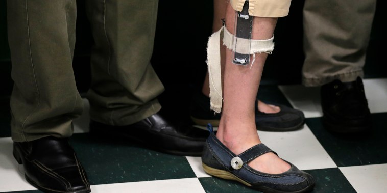 Image: A student wearing a shocking device on her leg, lines up with classmates after lunch at the Judge Rotenberg Educational Center in Canton, Mass., on Aug. 13, 2014.