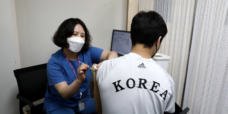 Image: South Korean Olympic judo team player An Ba-ul receives the first dose of the Pfizer-BioNTech Covid-19 coronavirus vaccine at the National Medical Center