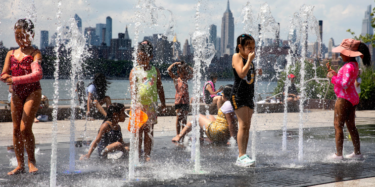 Children cool off in a fountain in Brooklyn, N.Y., on June 29, 2021.
