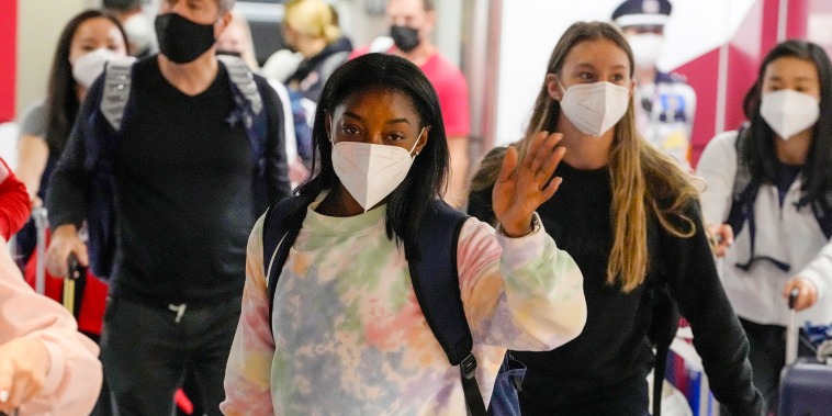 Image: Simone Biles, center, and the U.S. Women's Gymnastics team arrive for the Tokyo 2020 Summer Olympic Games at Narita International Airport