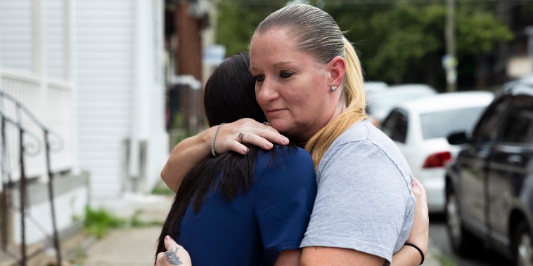 Miltreda Kress hugs her daughter, Brianna Donahue, in front of their home in Philadelphia.