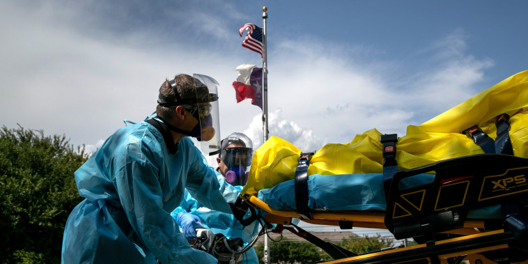 Image: Medics with Austin-Travis County EMS transport a nursing home resident with coronavirus symptoms on Aug. 3, 2020 in Austin, Texas.