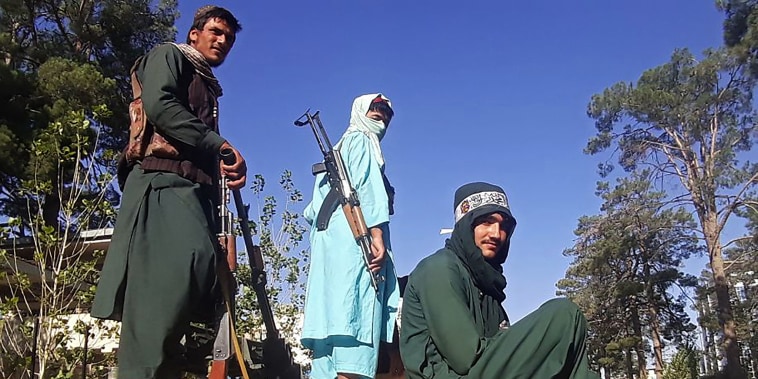Taliban fighters stand on a vehicle along the roadside in Herat, Afghanistan, on Aug. 13, 2021.