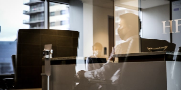 Employees wear protective masks in a conference room at a JLL office in Dallas, Texas, on Sept. 9, 2020.