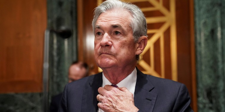 Federal Reserve Chair Jerome Powell adjusts his tie as he arrives to testify before a Senate hearing on July 15, 2021.