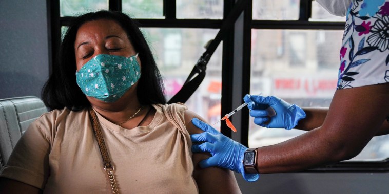A health worker administers a Pfizer Covid-19 vaccination at a mobile inoculation site in the Bronx, N.Y., on Aug. 16, 2021.