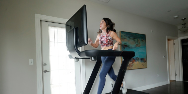 Image: Liza Lecher works out on her Peloton Tread+ treadmill on May 24, 2021 in Williamstown, N.J.