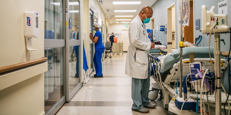 Image: A doctor tends to a patient in a hallway at the Houston Methodist The Woodlands Hospital on Aug. 18, 2021 in Houston, Texas.