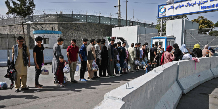 Image: Afghans, hoping to leave Afghanistan, queue at the main entrance gate of Kabul airport in Kabul on Aug. 28, 2021, following the Taliban military takeover of Afghanistan.