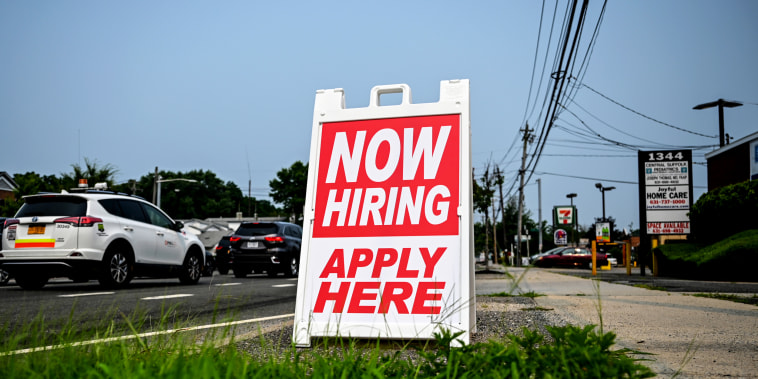A hiring sign stands along the road in Selden, N.Y., on July 20, 2021.