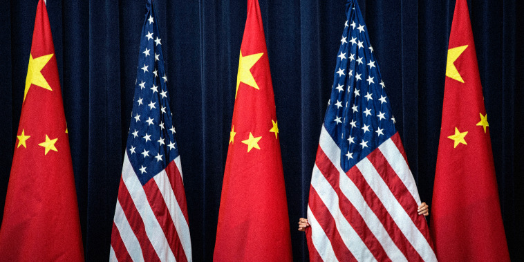 Image: A staff member adjusts an American flag before a U.S. and China Strategic and Economic Dialogue in Washington in 2013.