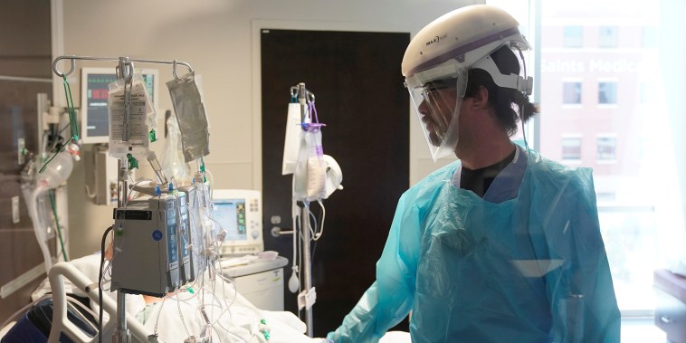 Image: A nurse works in a Covid patient's room at SSM Health St. Anthony Hospital's intensive care unit in Oklahoma City, on Aug. 24, 2021.