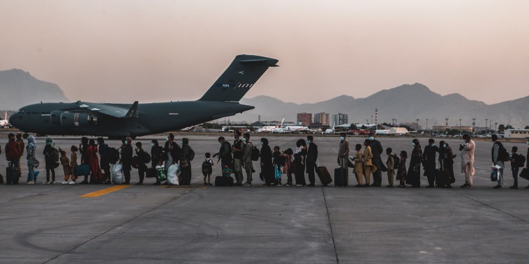 Evacuees wait to board a Boeing C-17 Globemaster III during an evacuation at Hamid Karzai International Airport, Kabul, Afghanistan, Aug. 23, 2021.