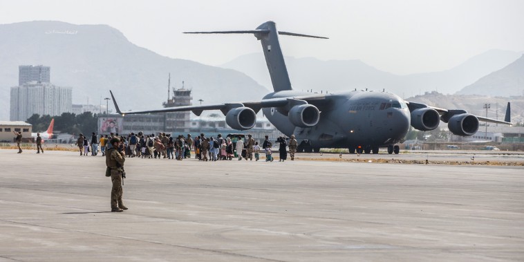 Evacuees load on to a U.S. Air Force Boeing C-17 Globemaster III during an evacuation at Hamid Karzai International Airport, Kabul, Afghanistan, Aug. 21., 2021.