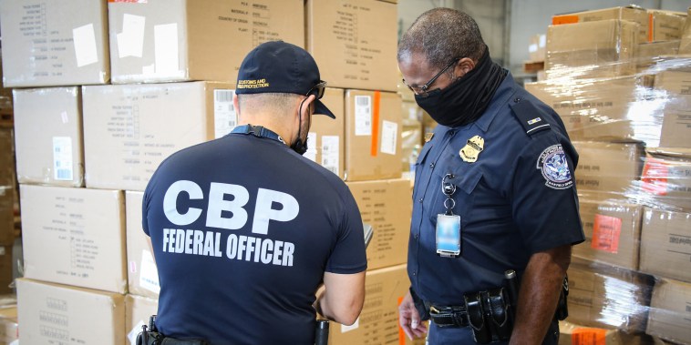CBP officers in Atlanta inspect apparel suspected to be made with cotton harvested by forced labor in China's Xinjiang Region, August 2021.