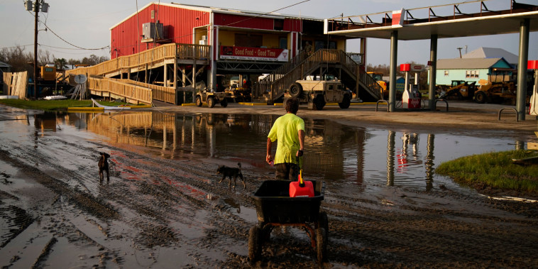 A man goes for gas at a hurricane-damaged gas station in the aftermath of Ida on Sept. 6, 2021, in Grand Isle, La.