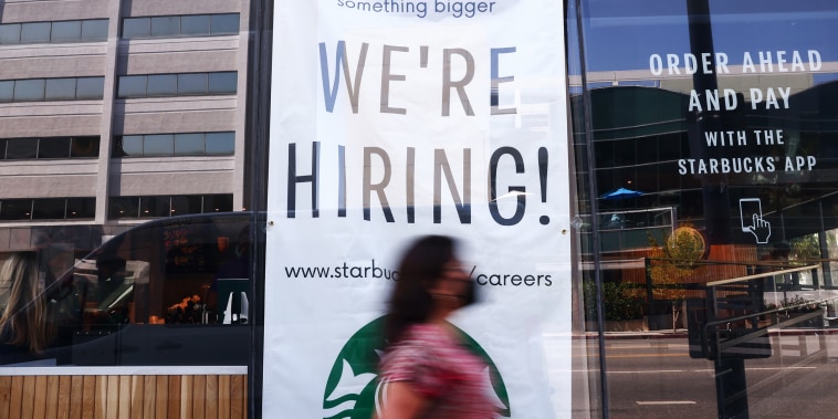 A "We're Hiring!" sign is posted at a Starbucks on Aug. 6, 2021 in Los Angeles.