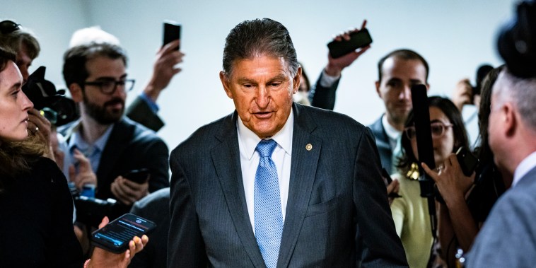 Sen. Joe Manchin, D-W.Va., is surrounded by reporters as he heads to a vote in the Senate on June 8, 2021, in Washington.