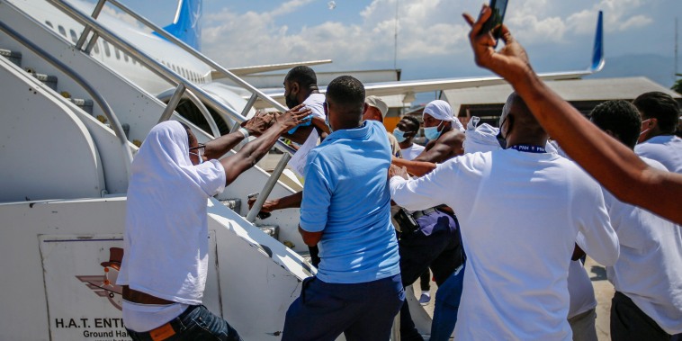 Image: Deported Haitians try to board plane back to USA